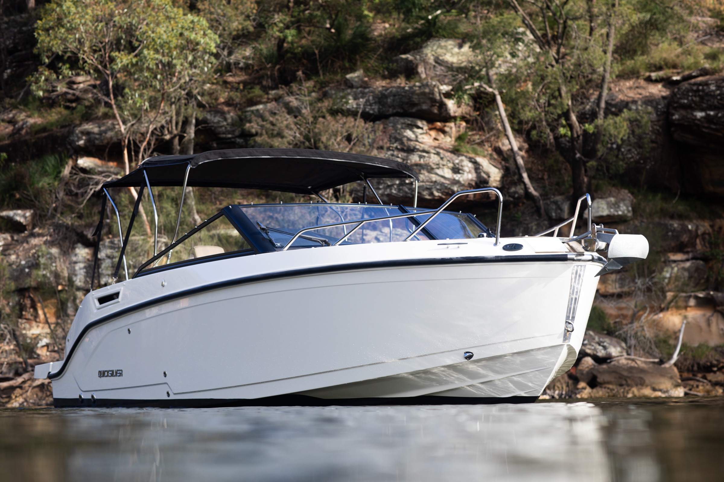 Boat moored against rocky Hawkesbury cliffs